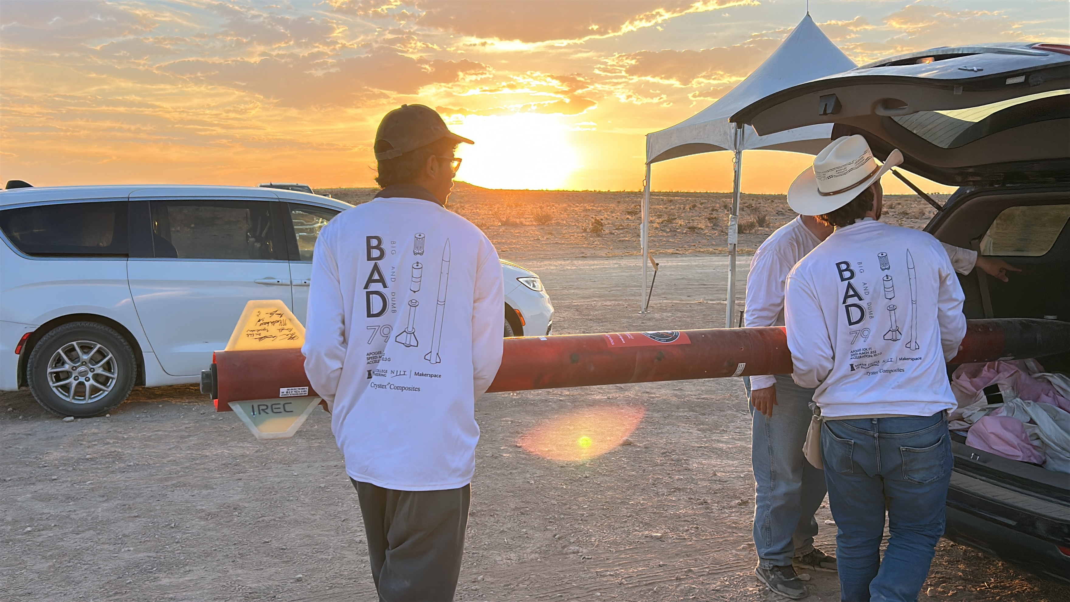 NJIT Rocketry Club loading a rocket at sunset